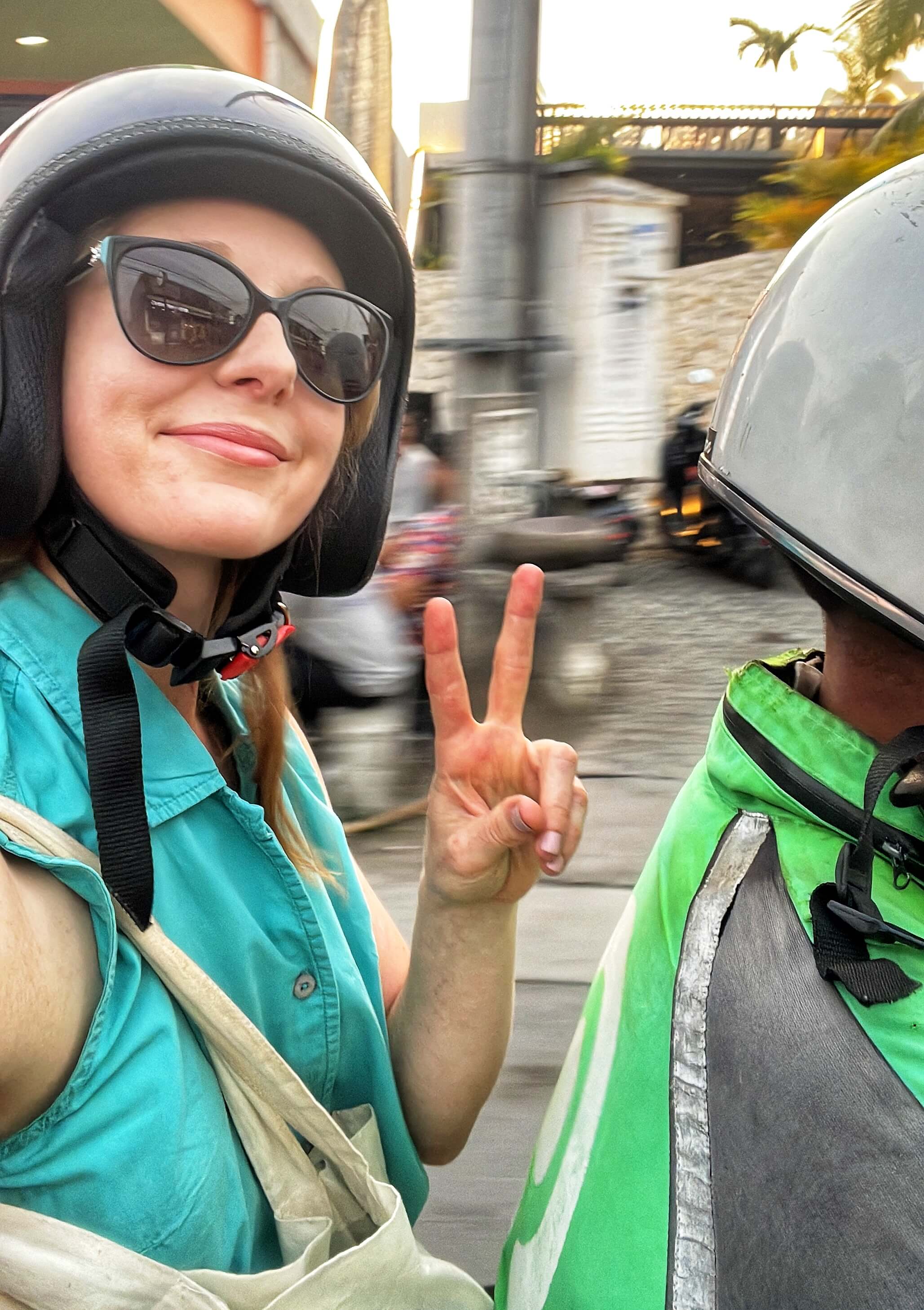 Clara Ritger rides on the back of a motorcycle in Bali, Indonesia.