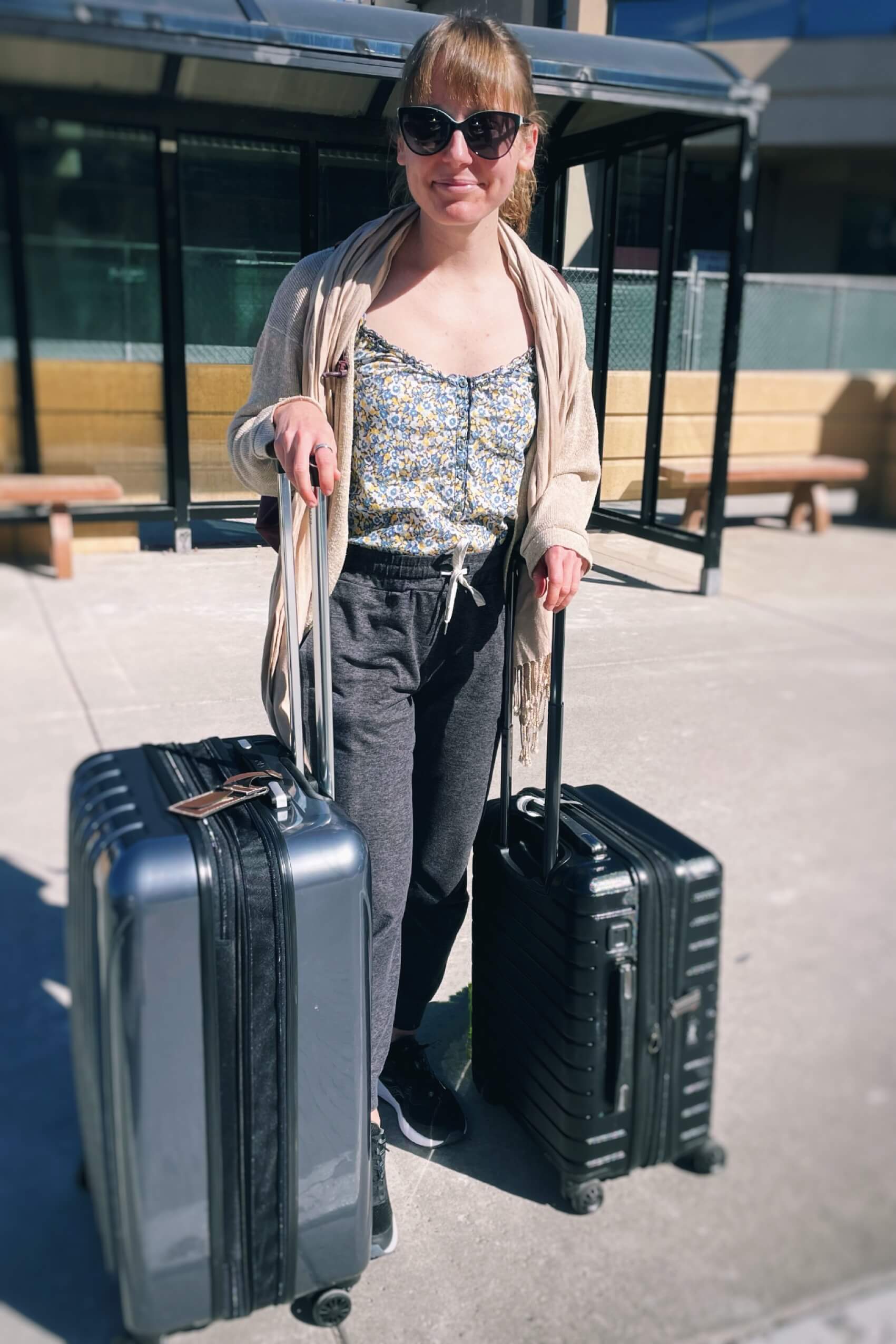 Clara Ritger at the airport with two suitcases.