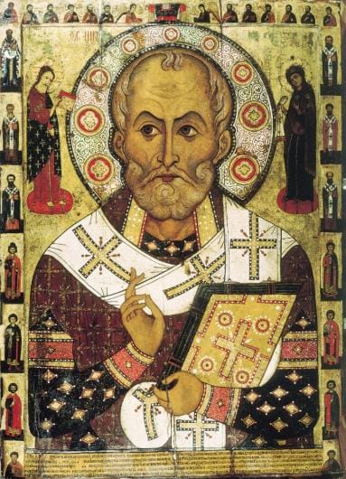 Saint Nicholas depicted in red robes, with a halo around his head and bible in his arms.