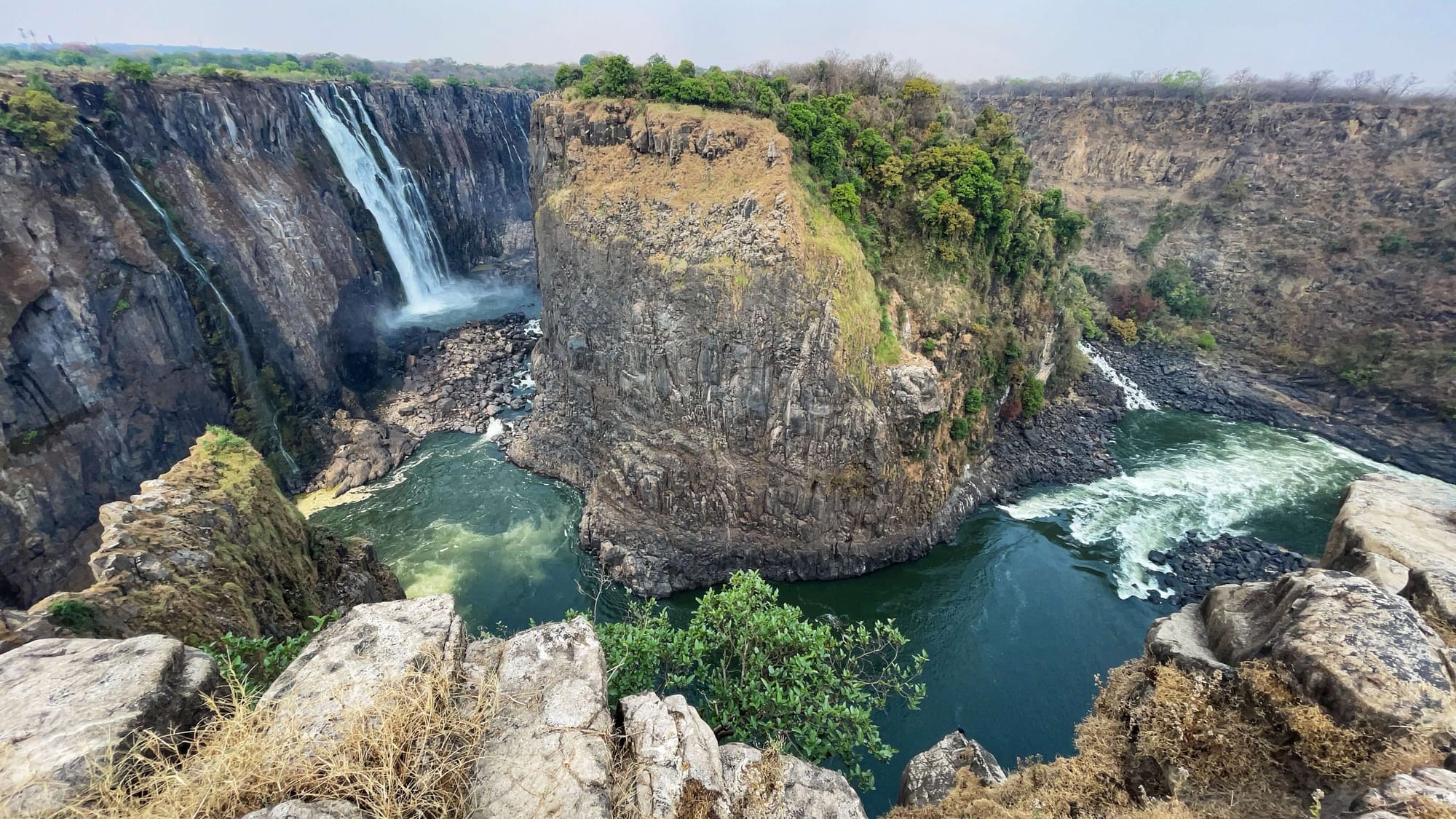 A super wide shot of a bend in the river at the base of Victoria Falls.