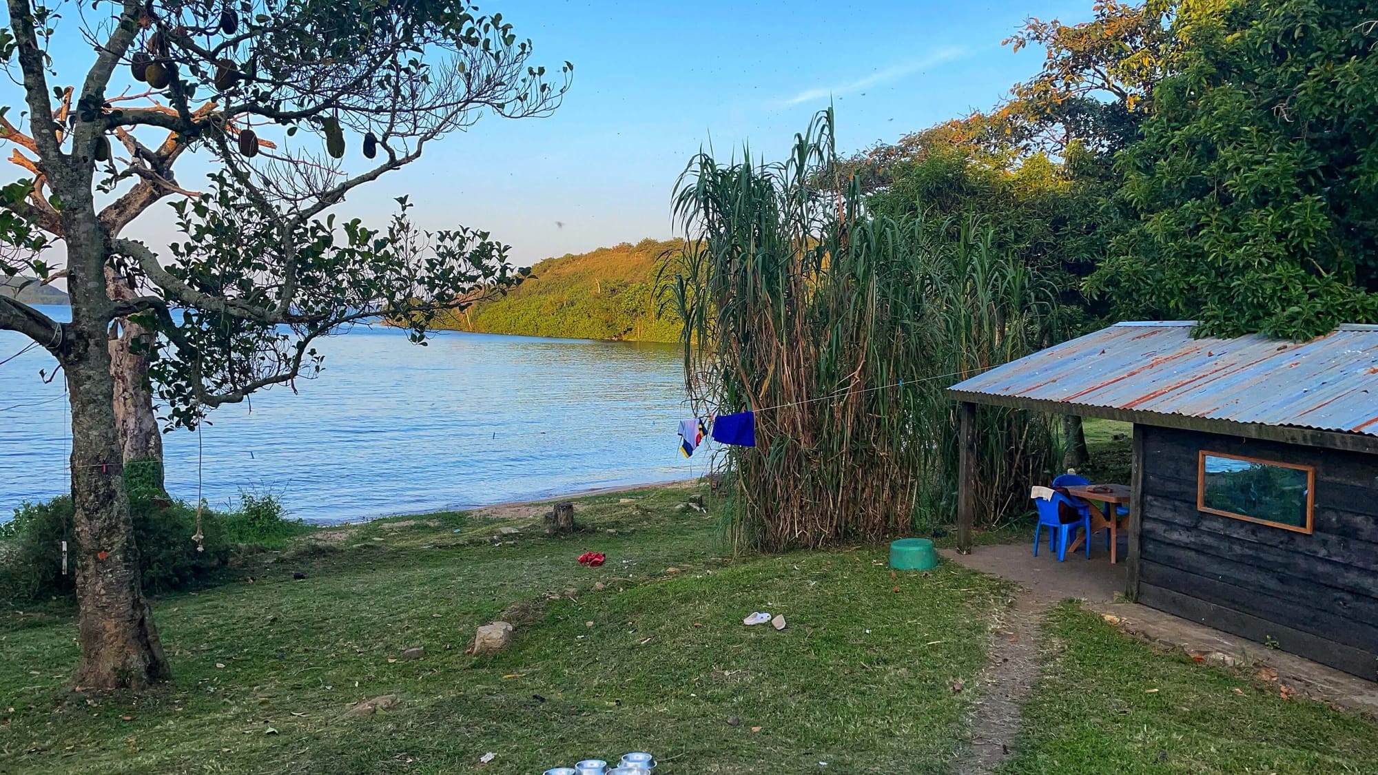 A view of the lake, a cabin, and a table where the card game is played.