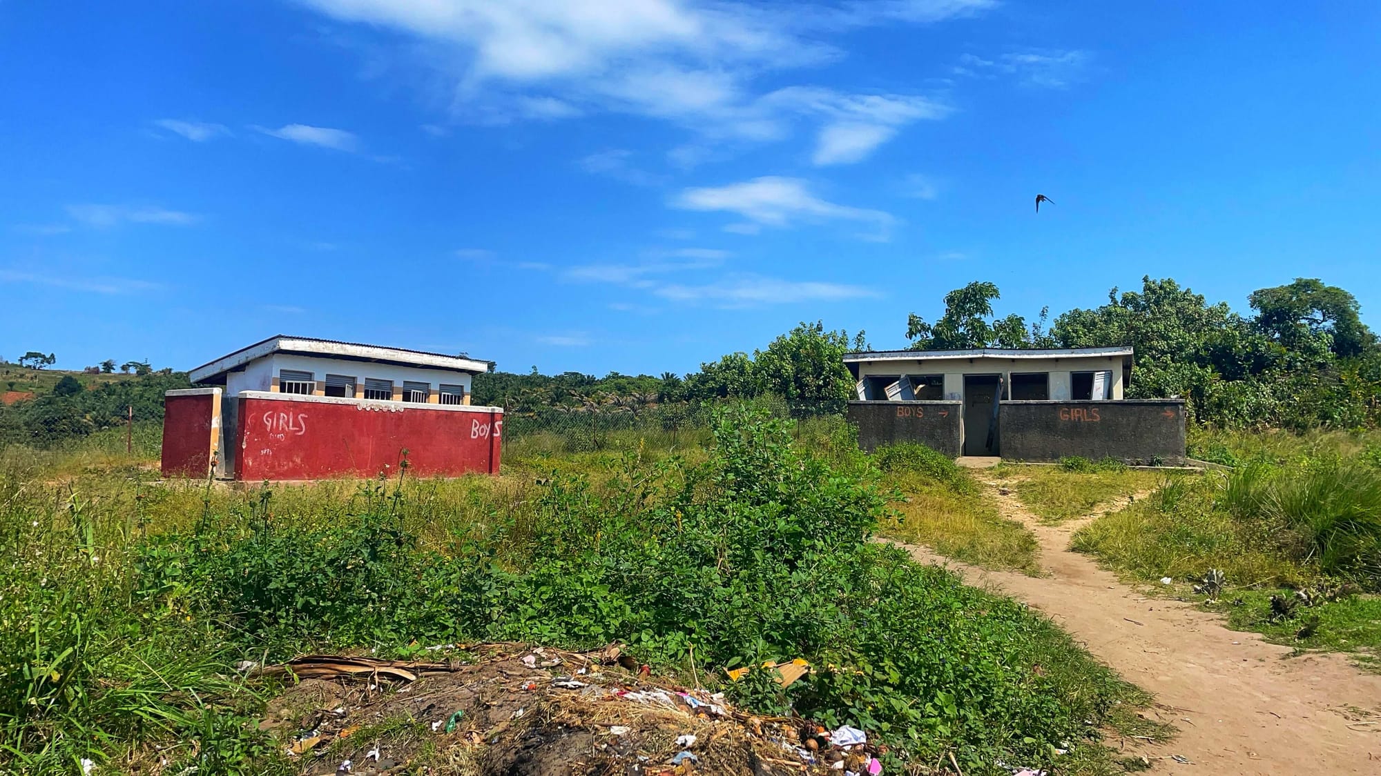 Two toilet buildings with sides marked "GIRLS" and "BOYS."